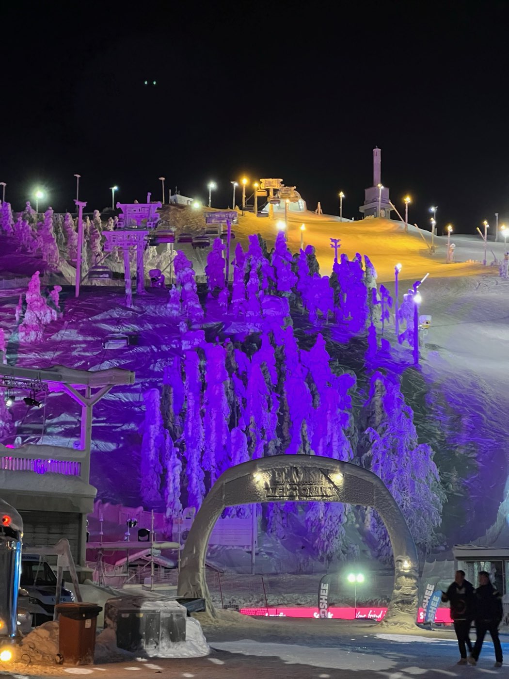 Ruka slopes lit purple and gold at night